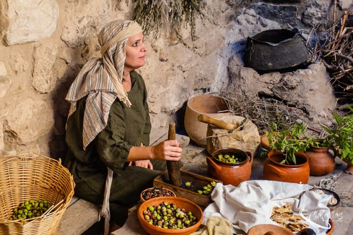 Crushing olives and making bread
